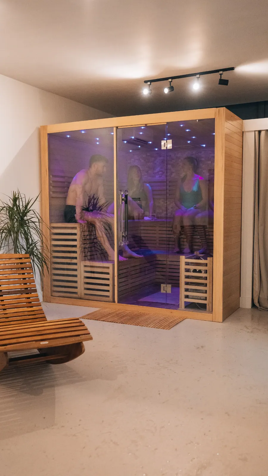 The glass-fronted traditional sauna cabin at Revitalise Hub