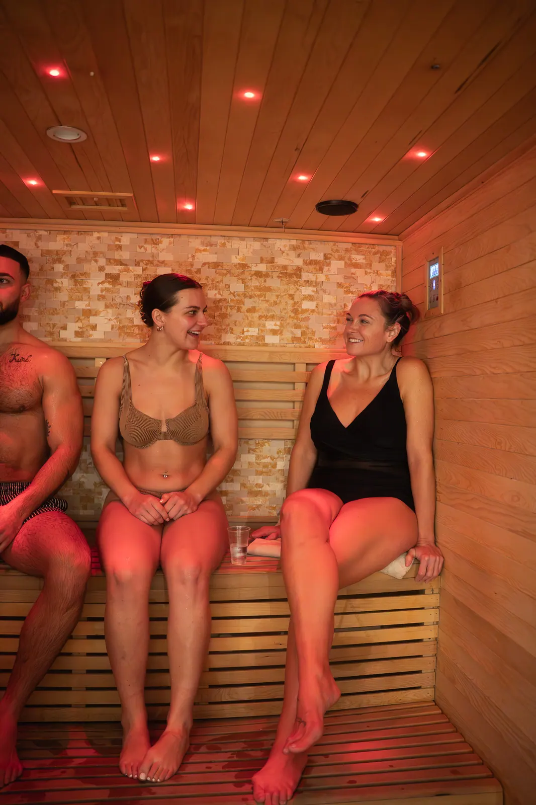 Guests relaxing together in the traditional sauna at Revitalise Hub
